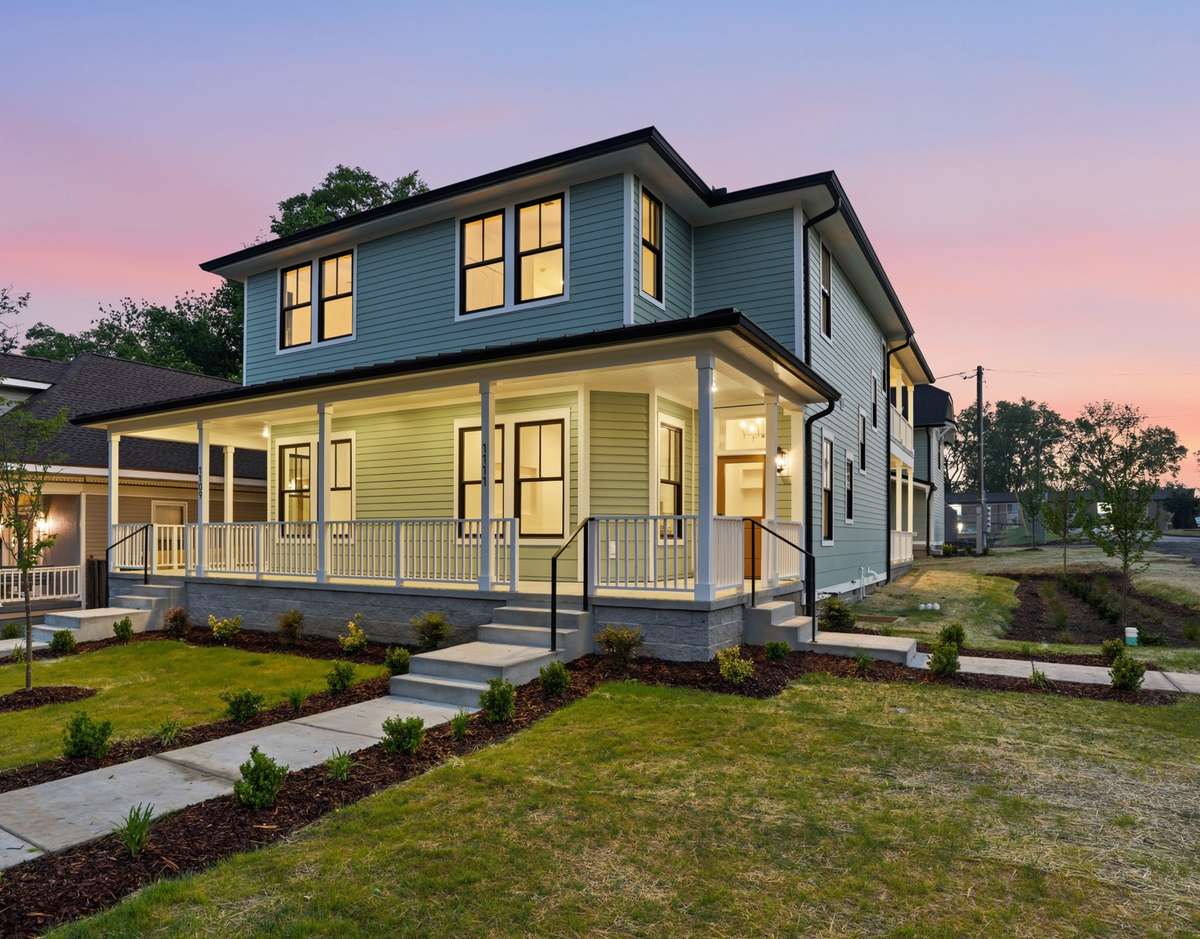 A clean concrete sidewalk leads you past fresh landscaping straight to the front steps.