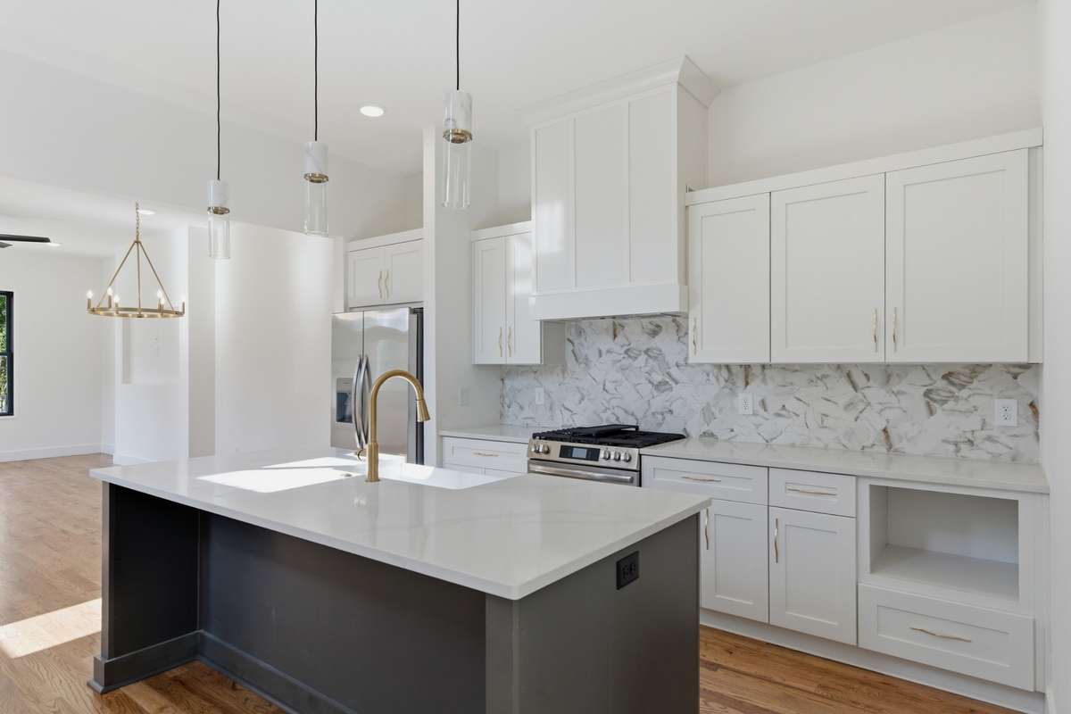The oversized island offers plenty of room to comfortably fit four barstools for casual dining or entertaining.