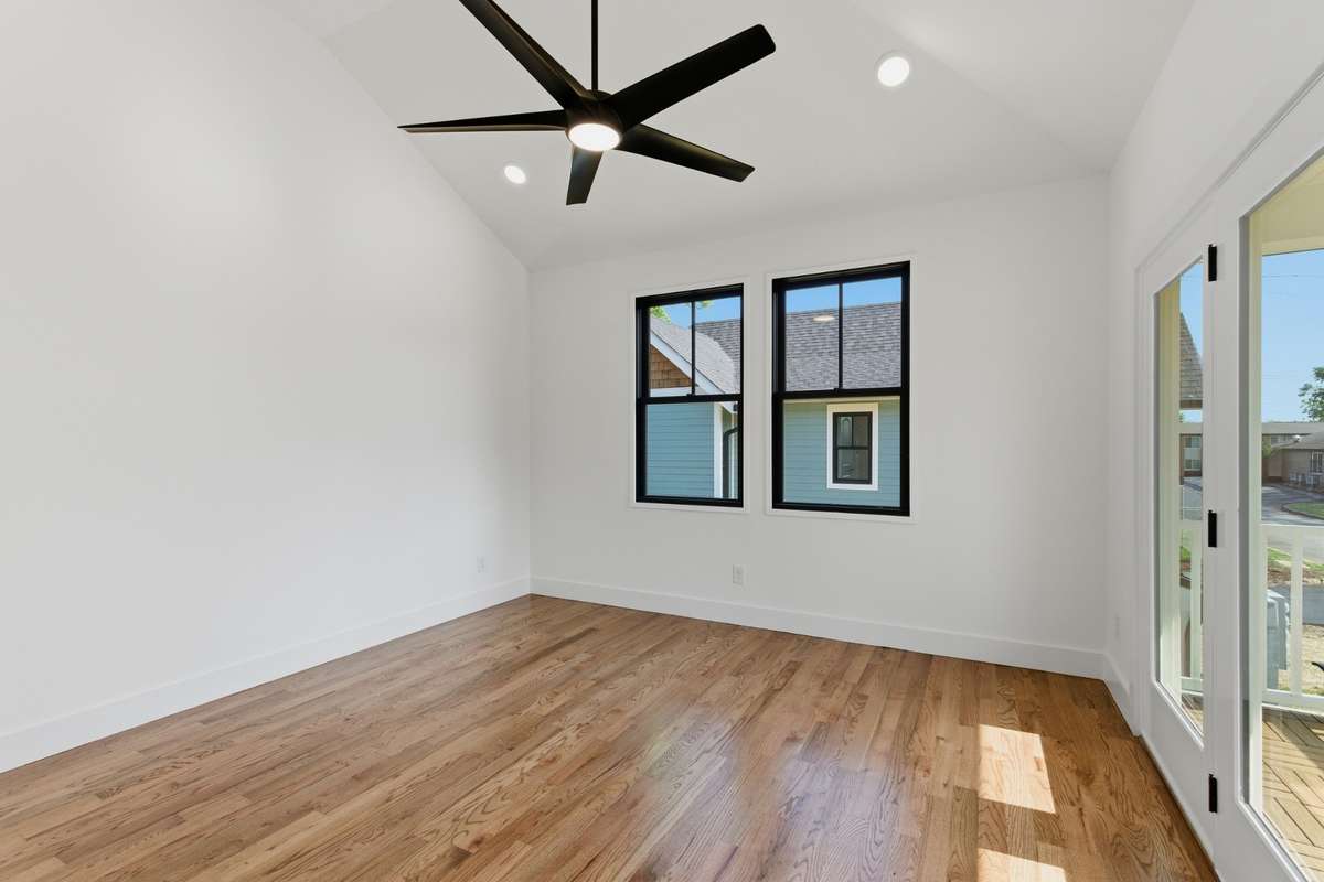Located on the second level, the primary suite features impressive vaulted ceilings and beautiful walnut hardwoods.