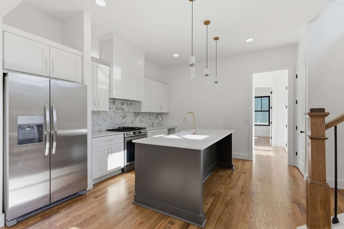 Walking into the kitchen, you’re greeted by a clean, open design centered around a large centered island.