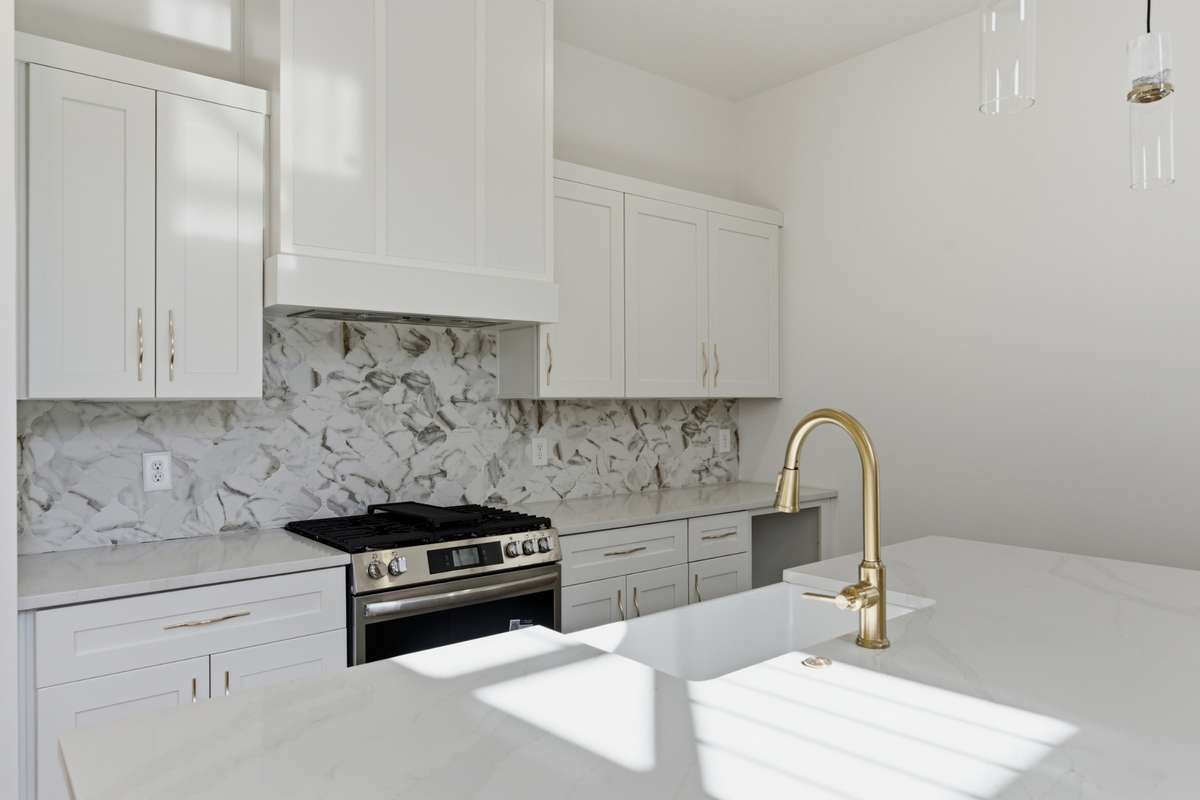 You’ll love the high-end look of the marble backsplash and the elegant gold hardware throughout the room.
