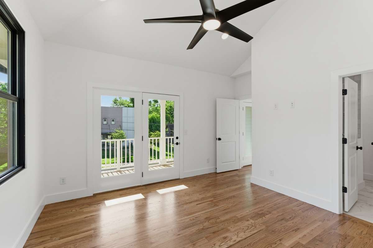 Large windows and a private glass door lead out to a dedicated balcony, perfect for enjoying quiet East Nashville mornings.
