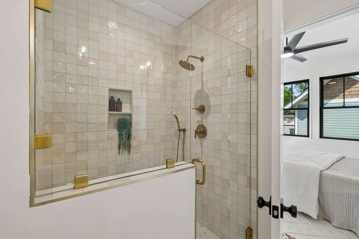 The custom-built shower features beautiful tile work and an upgraded dual showerhead.