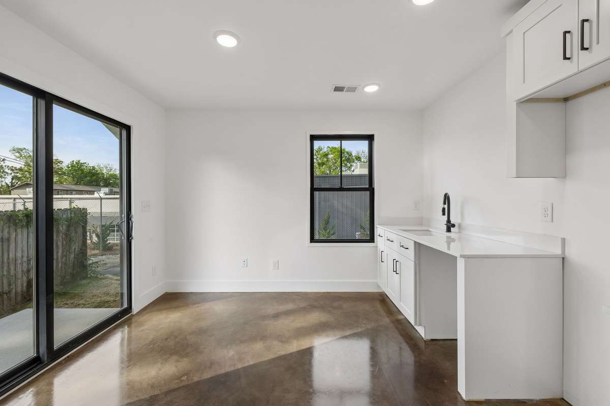 The first floor offers a sunny living/dining area with glass doors that lead to a private patio.