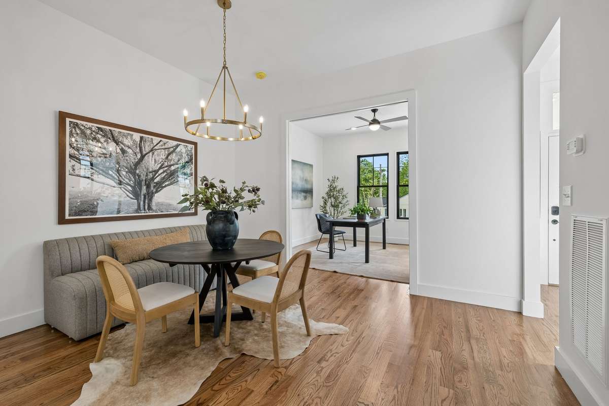 A modern chandelier illuminates the dining room, just one of many elegant lighting selections.