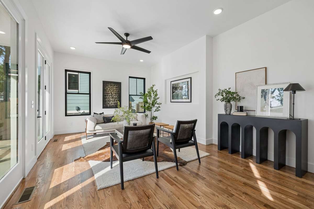 Continue into the living room, a bright and welcoming space where you can easily picture yourself relaxing after a busy day.