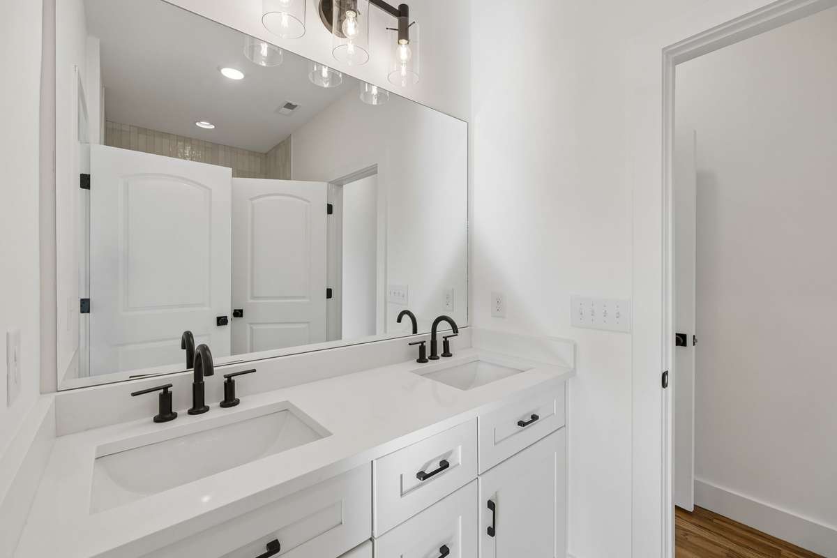 Another full bath connects the two bedrooms. Double vanities and extra cabinet space make this bathroom easy to share