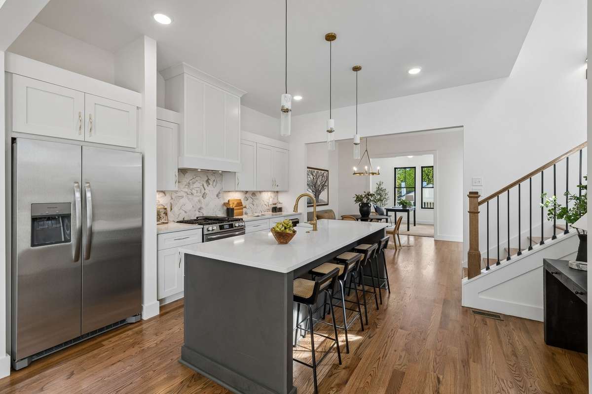 The wide quartz island doubles as a charming breakfast bar.
