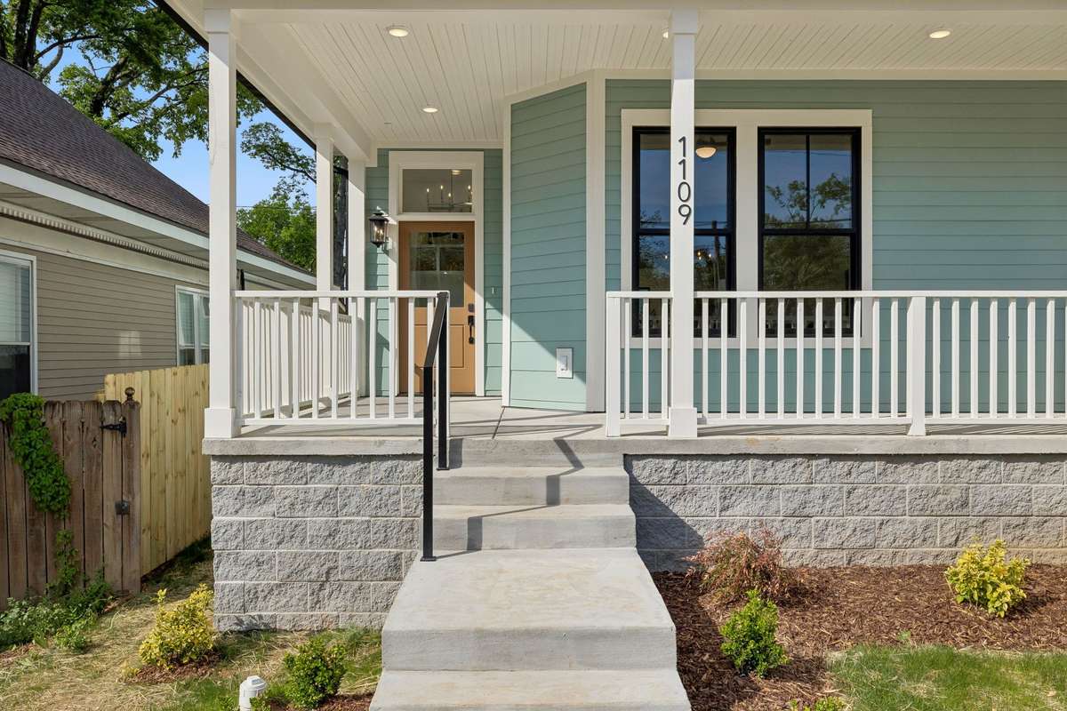 The wraparound front porch is perfect for welcoming guests!