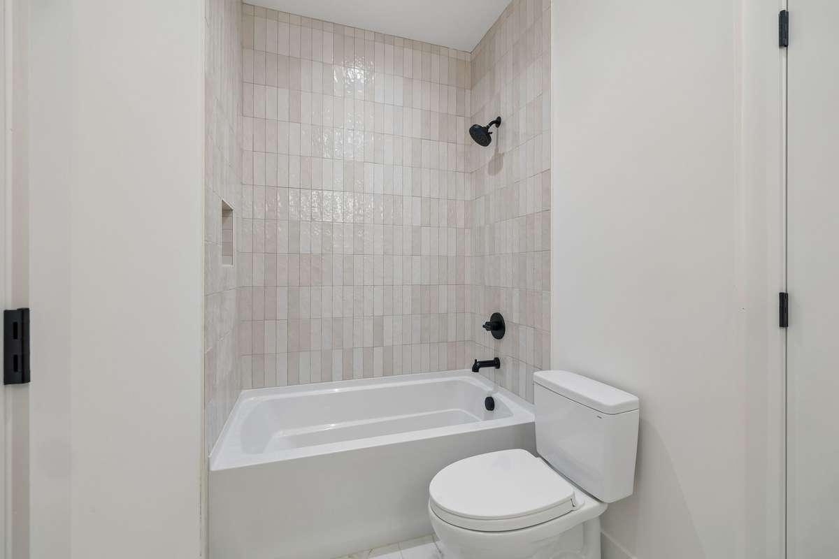 It also has a deep bathtub lined with a lovely tile surround.