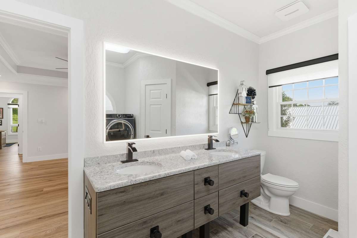 Master bath features double vanity standing shower and tiled floor.