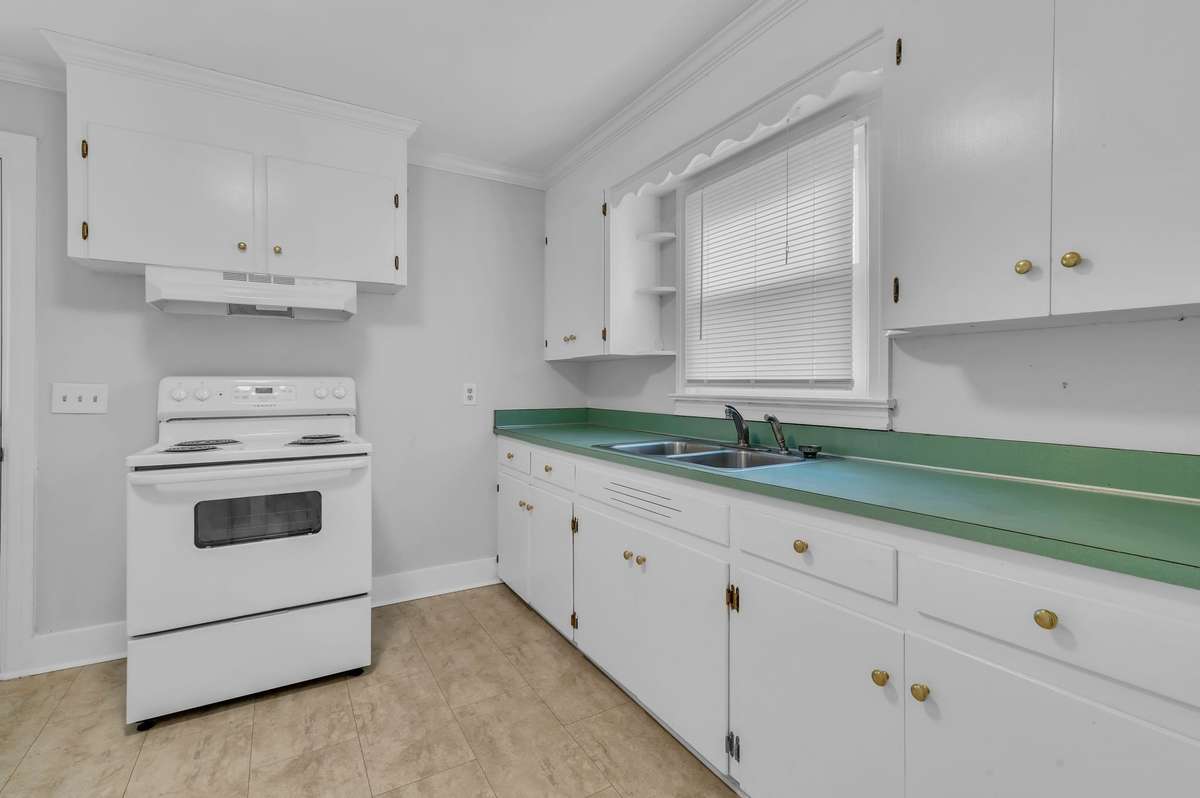 Kitchen has a side door coming in from the carport and a closet pantry next to the refrigerator