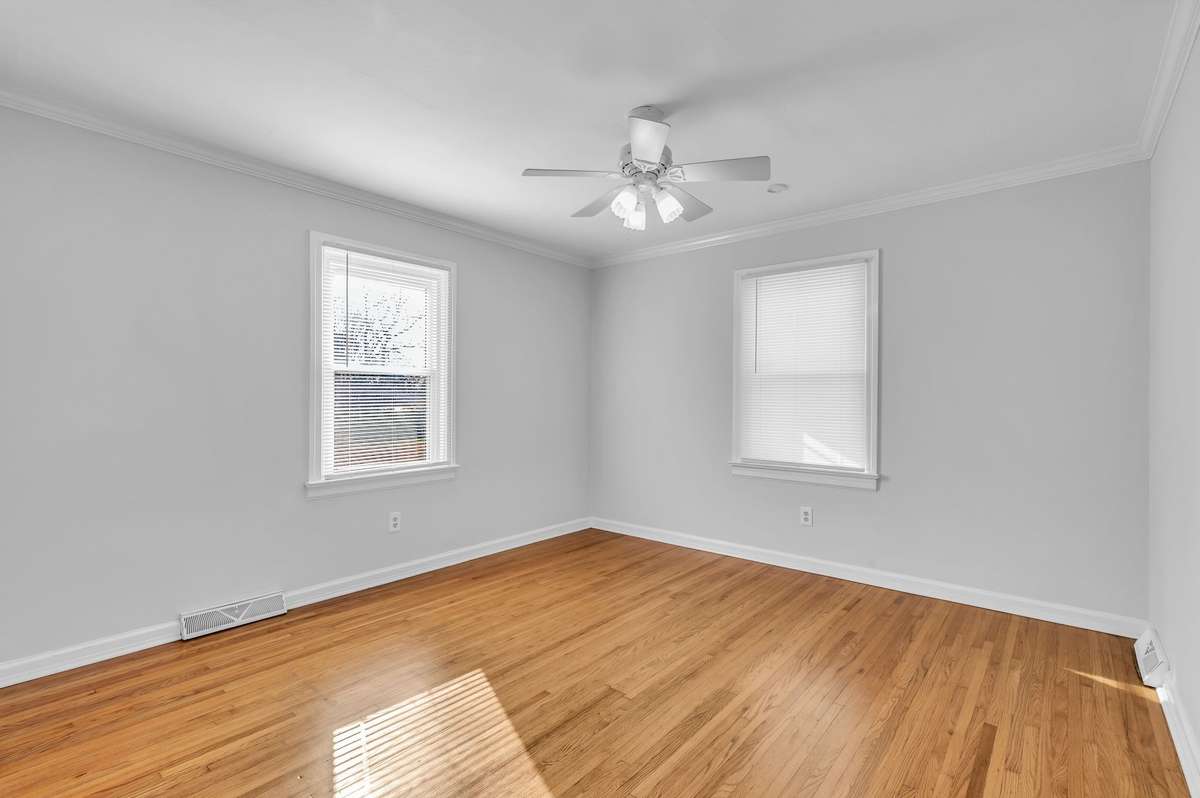 Guest bedroom with new blinds and hardwood floors