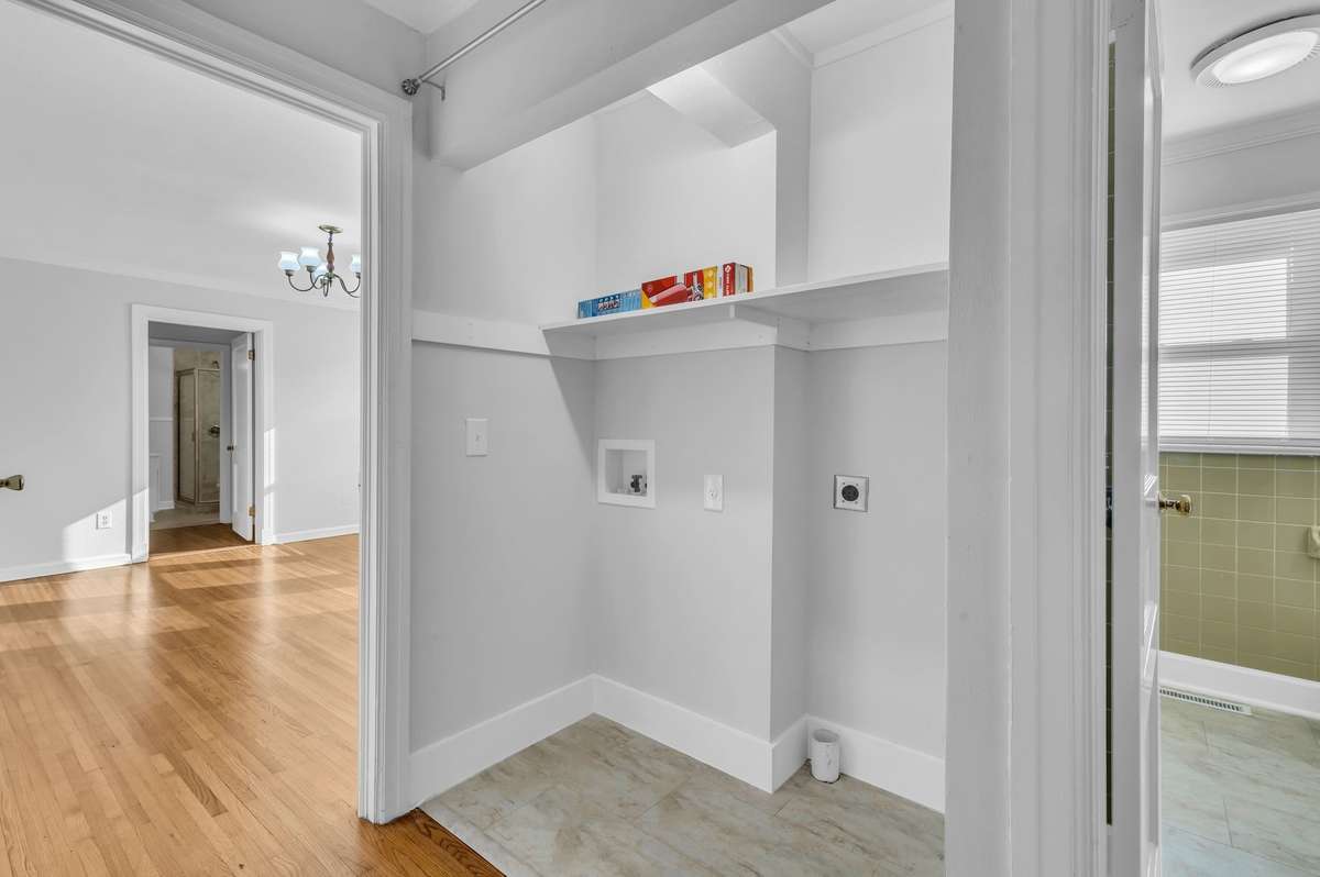 Hallway laundry closet with rod already installed for curtains to hide your washer and dryer