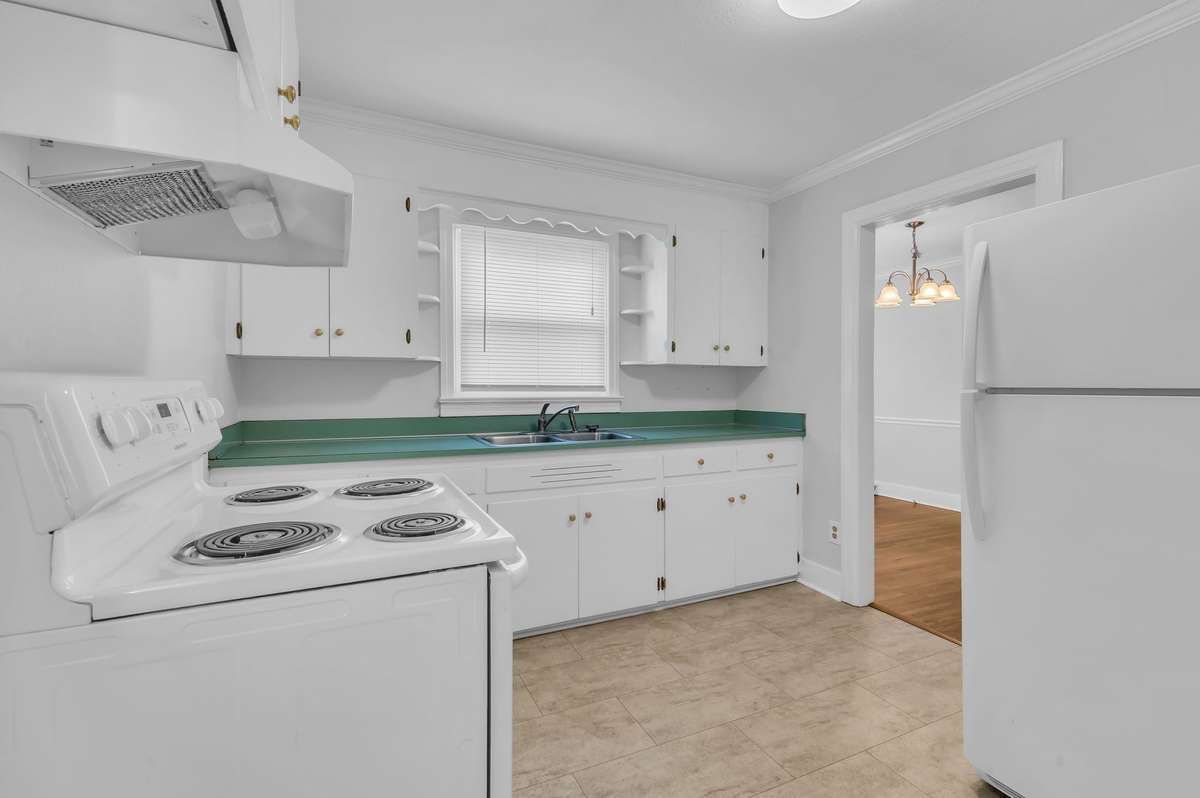 Cute kitchen with newer appliances and painted white cabinets