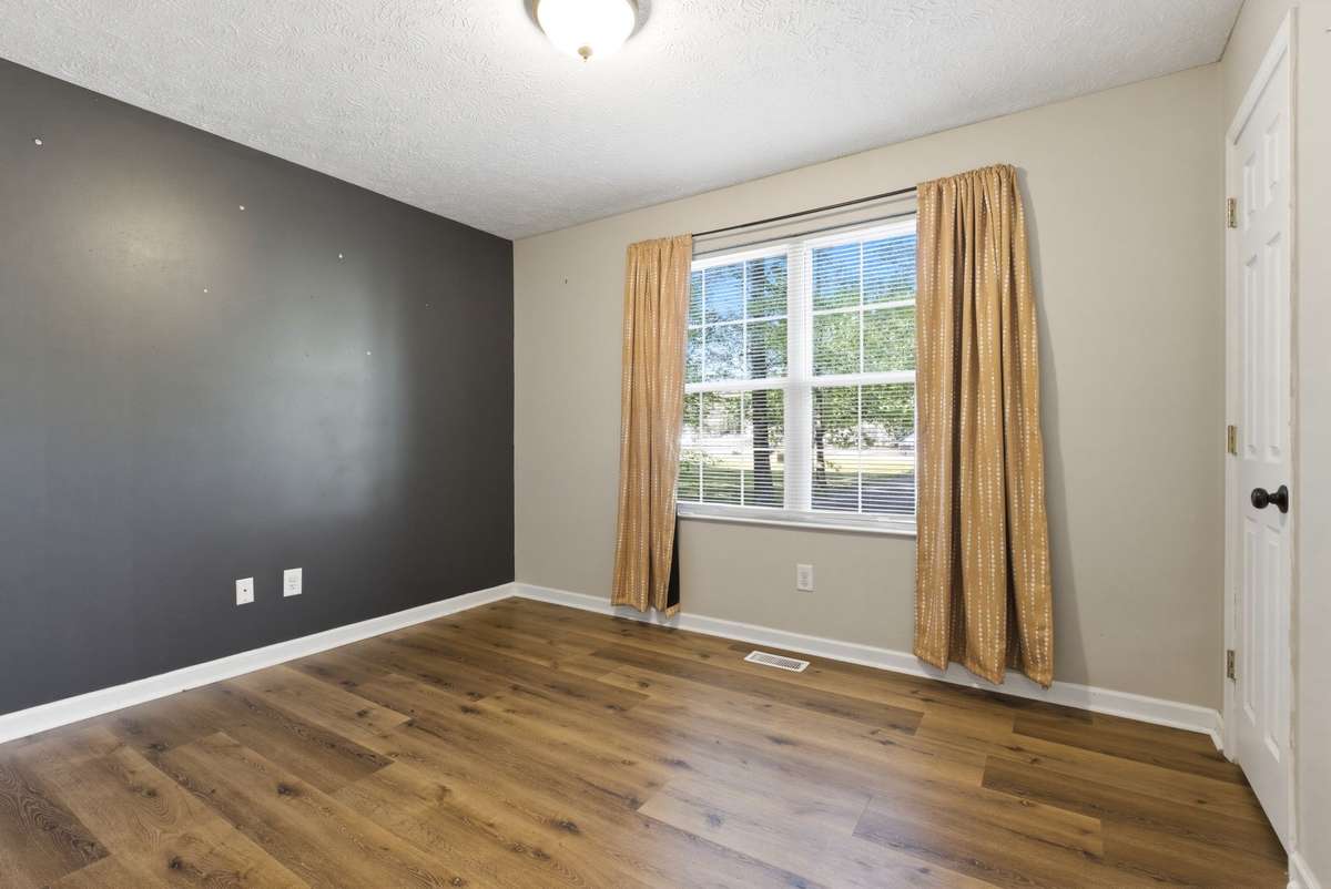 Second bedroom has plenty of sunlight, and two closets with custom shelving.