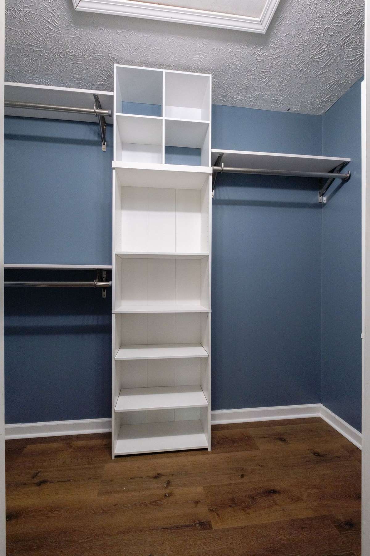 Awesome walk-in closet to include custom shelving.