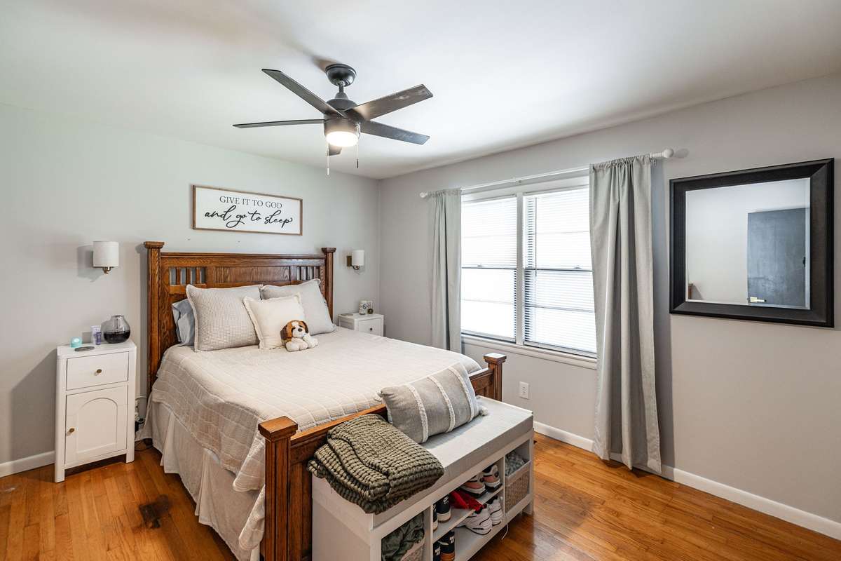 Primary bedroom with original hardwood flooring is a spacious, relaxing retreat~