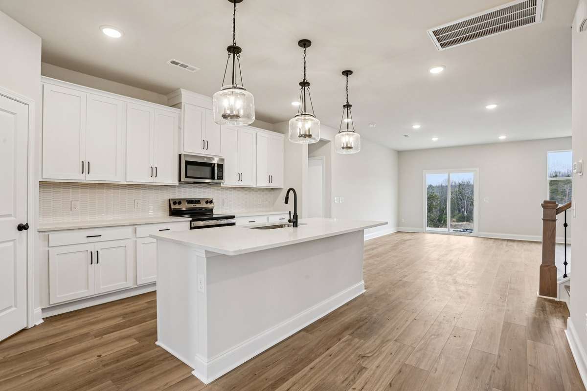 The kitchen opens effortlessly to the breakfast area and great room, creating an ideal space for everyday living and entertaining.