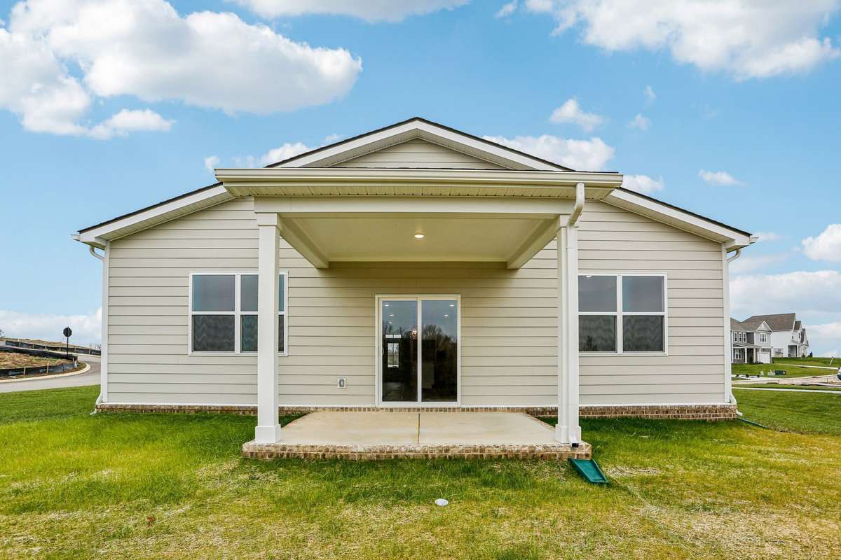 Enjoy year-round outdoor living on the spacious covered rear patio—perfect for relaxing, dining, or entertaining. Overlooking the backyard, this sheltered space offers comfort and shade with seamless indoor-outdoor flow.