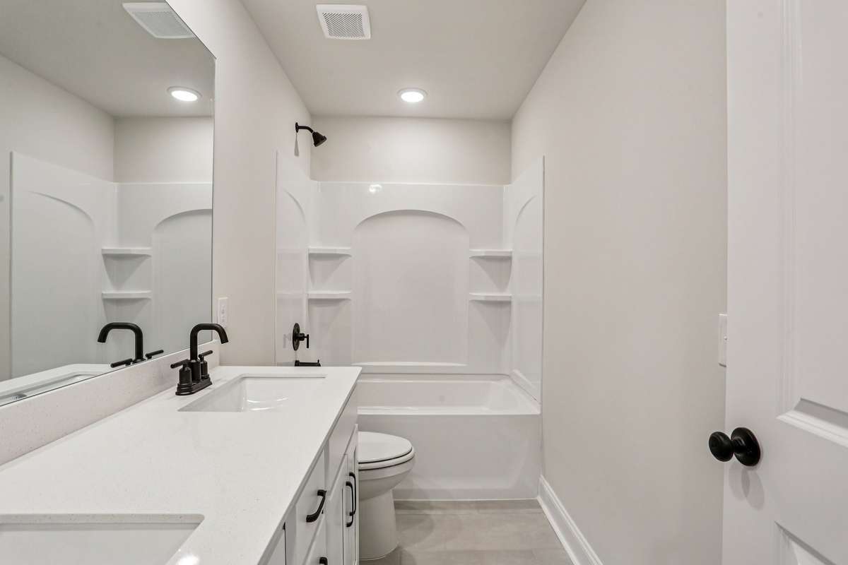 Bath #2 is located on the 2nd floor and includes double sinks with quartz countertops and tile flooring.
