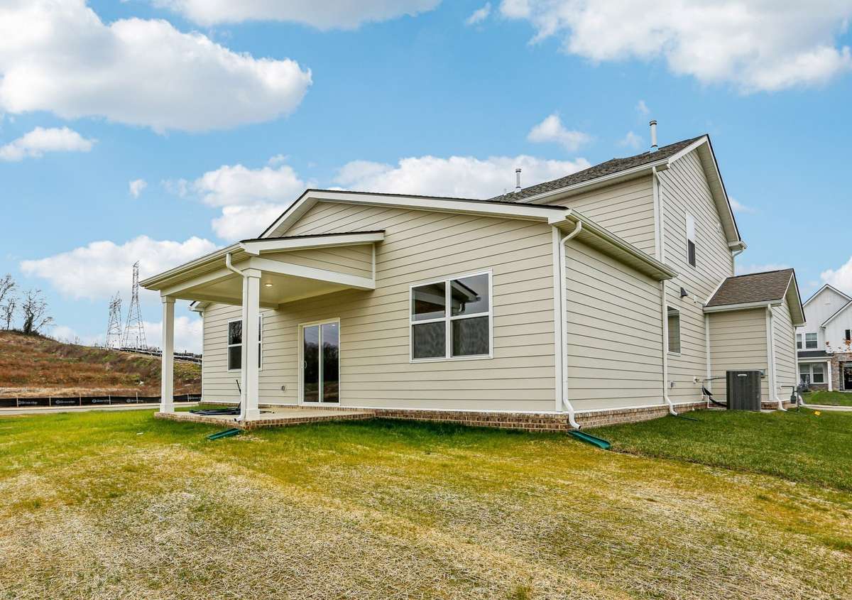 Beautiful rear exterior view showcasing a well-designed home on a desirable corner homesite. Enjoy added privacy, extra space, and amazing views.
