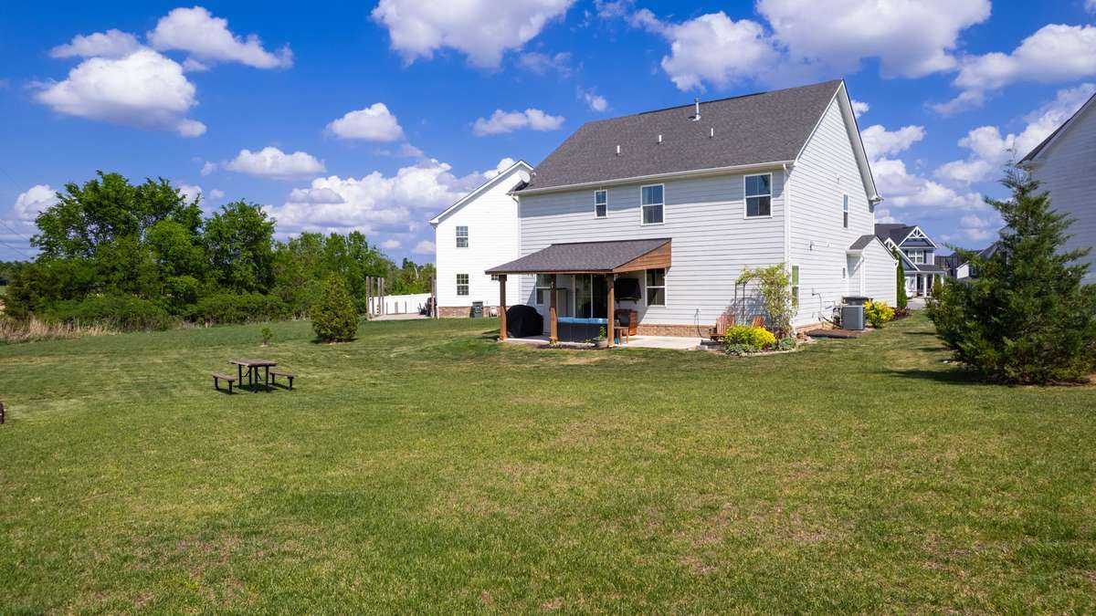 Expansive level backyard offering endless outdoor possibilities
