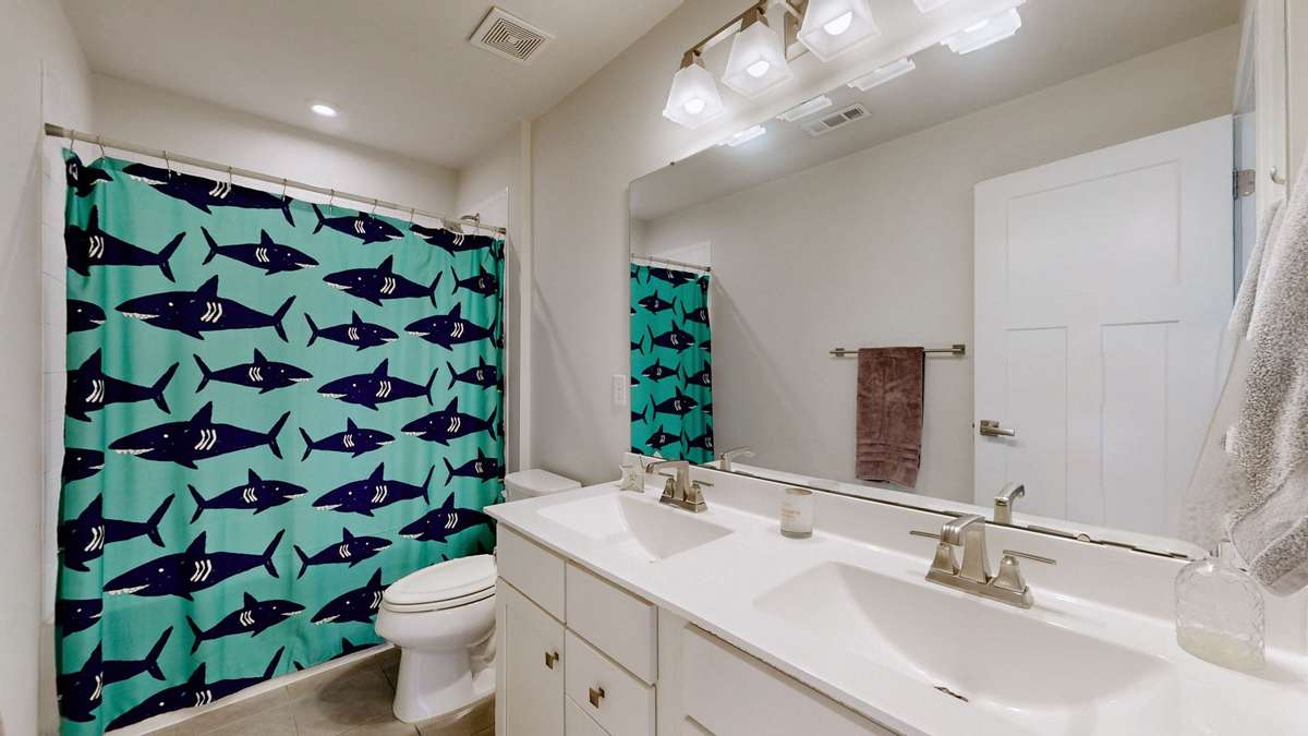 Upstairs guest bathroom with double vanities for added convenience