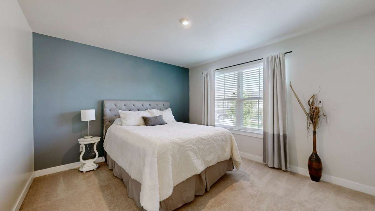 Bright guest room with double windows and walk-in closet