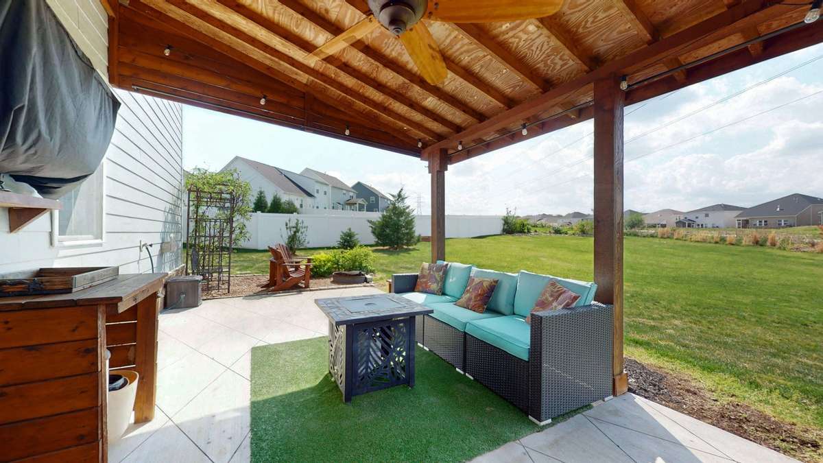 Covered outdoor living space with room for seating, dining & grilling