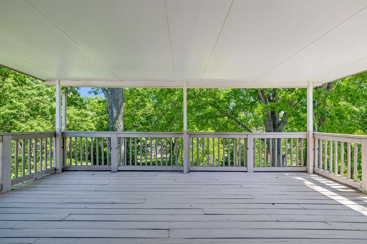 Expansive covered deck off the dining room—perfect for outdoor entertaining and enjoying the private, tree-lined setting.