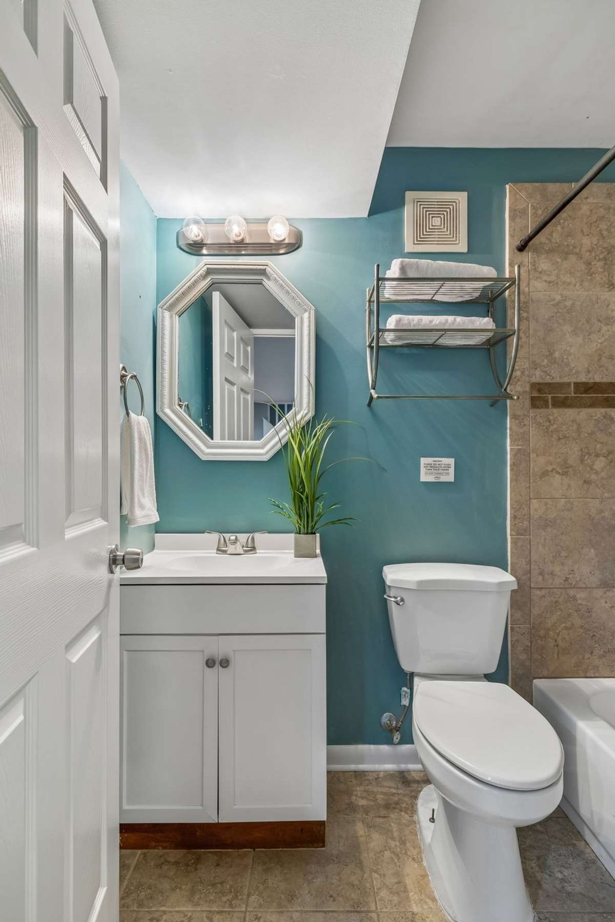 Full bathroom in the basement, conveniently located with the lower-level primary suite.