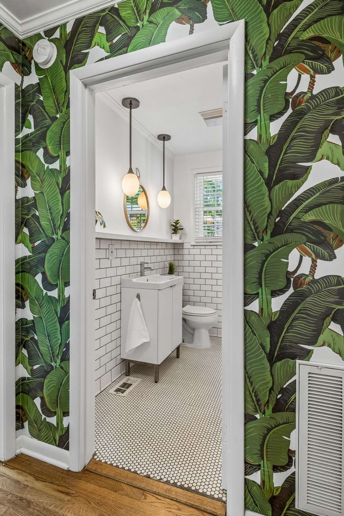 Stylishly updated main-level bathroom with classic tile, modern fixtures, and fresh, bright finishes.