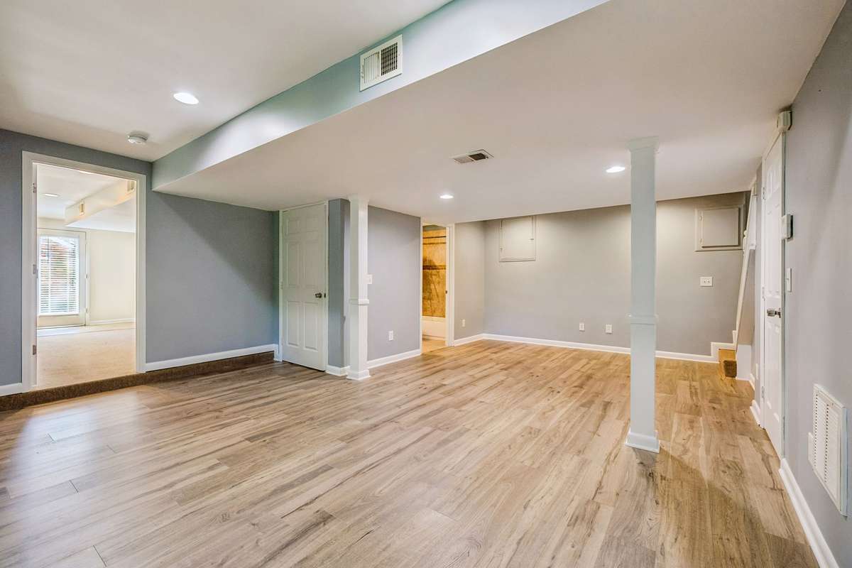 Lower-level primary suite with brand new luxury vinyl flooring and private entrance—ideal for an owner-occupied rental or guest space.