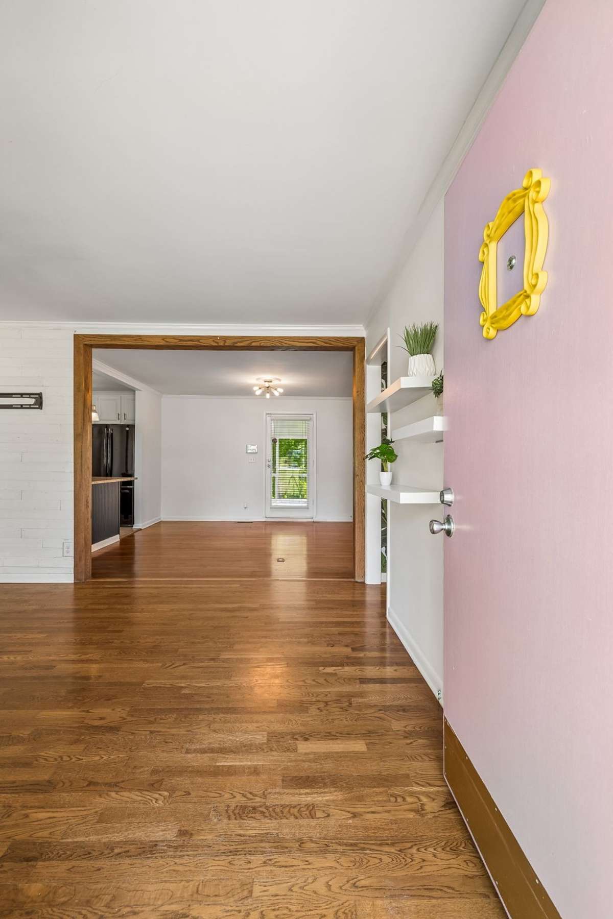 Spacious living room with abundant natural light and hardwood floors, offering plenty of room to relax or entertain.