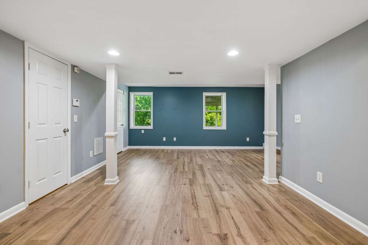 Lower-level primary suite with brand new luxury vinyl flooring and private entrance—ideal for an owner-occupied rental or guest space.