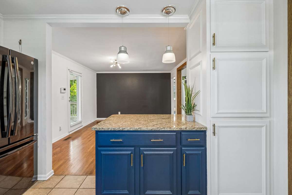 Kitchen island opens seamlessly to the dining area, ideal for everyday living and entertaining.