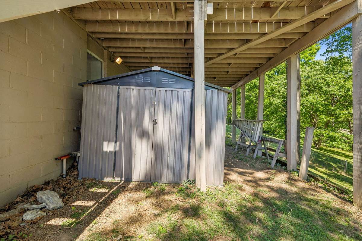 Outdoor storage shed provides convenient space for tools, lawn equipment, or additional storage.