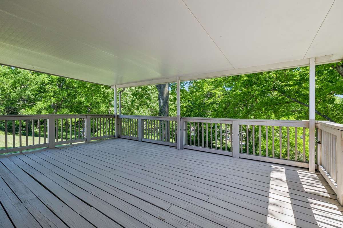 Expansive covered deck off the dining room—perfect for outdoor entertaining and enjoying the private, tree-lined setting.