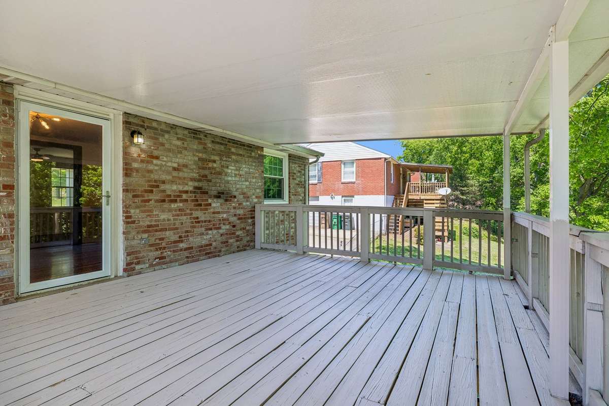 Expansive covered deck off the dining room—perfect for outdoor entertaining and enjoying the private, tree-lined setting.