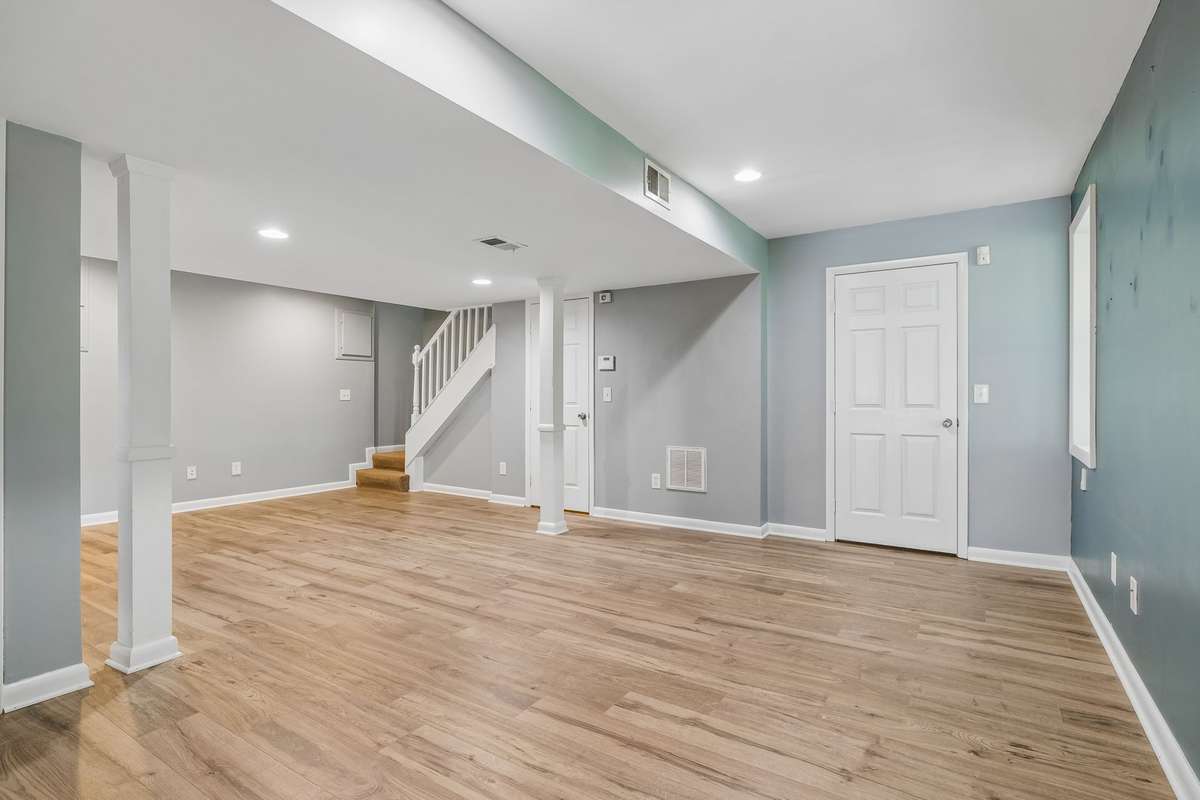 Lower-level primary suite with brand new luxury vinyl flooring and private entrance—ideal for an owner-occupied rental or guest space.