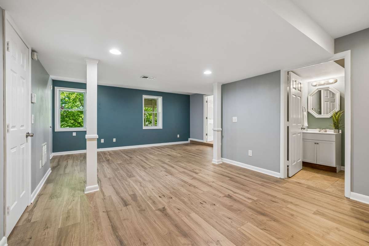 Lower-level primary suite with brand new luxury vinyl flooring and private entrance—ideal for an owner-occupied rental or guest space.