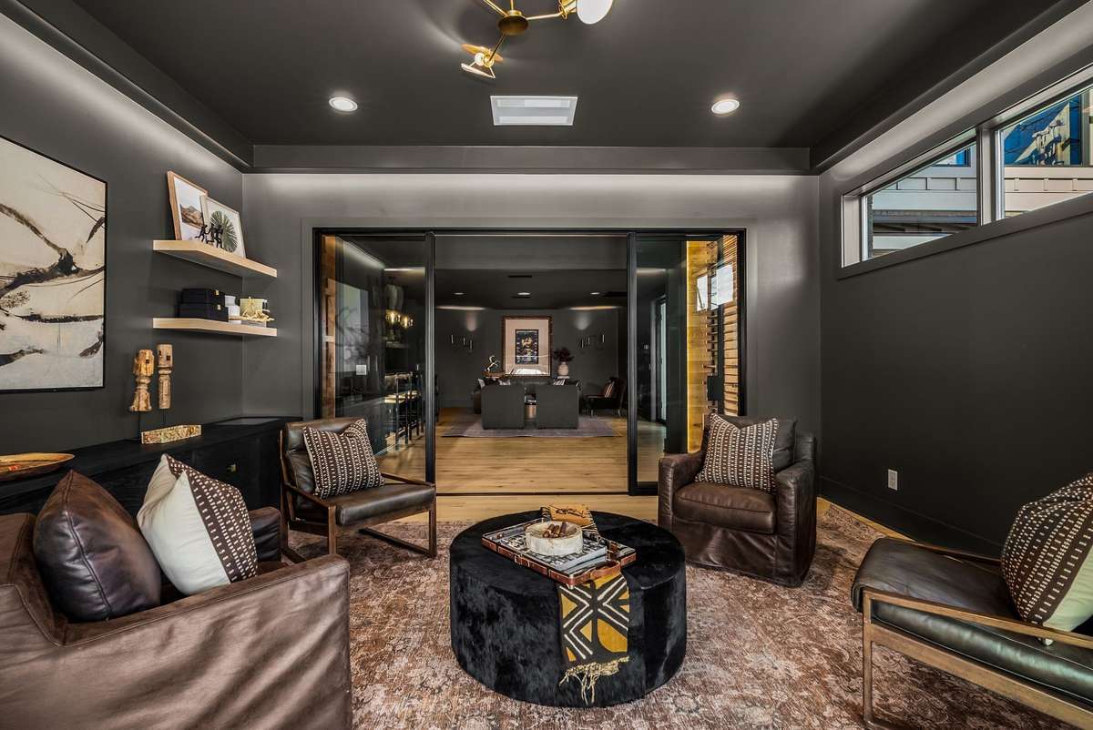 A refined cigar lounge featuring large glass doors that open the space while maintaining an intimate feel.