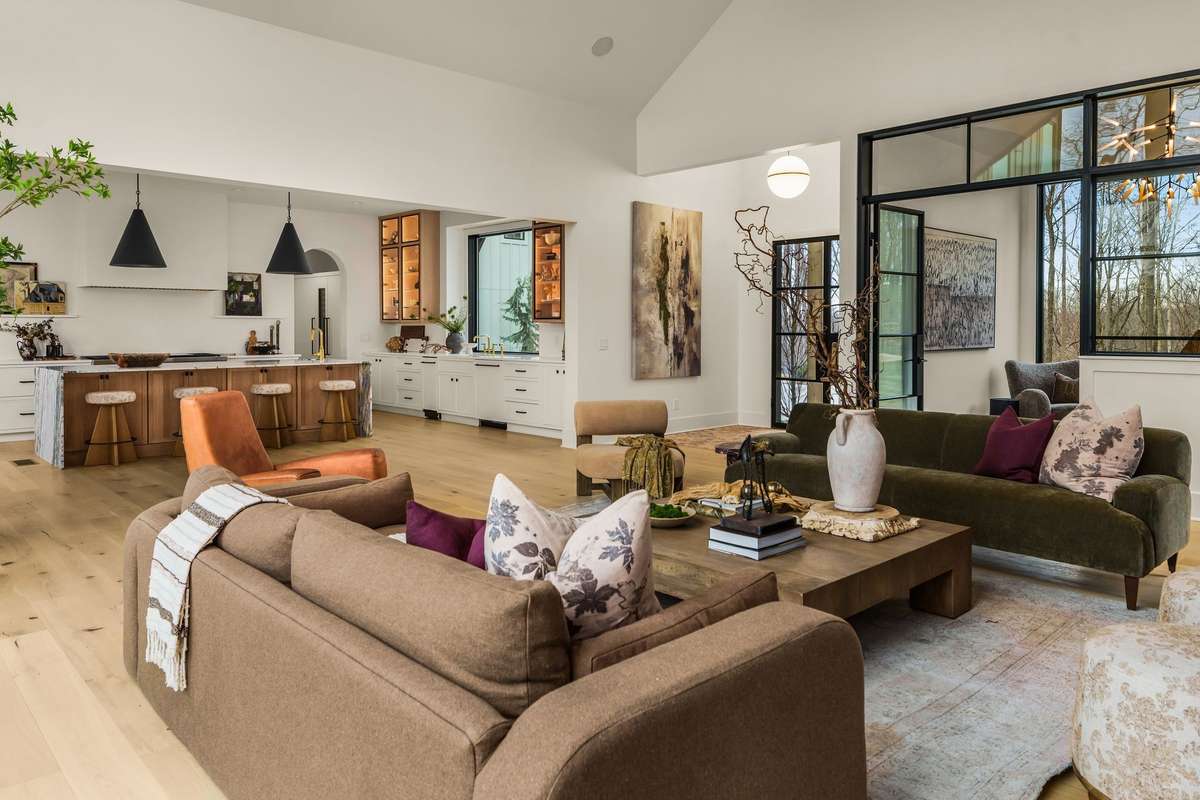 Open living room layout showcasing seamless flow between the living area and kitchen, with vaulted ceilings, thoughtful proportions, and an inviting arrangement designed for both everyday living and entertaining.