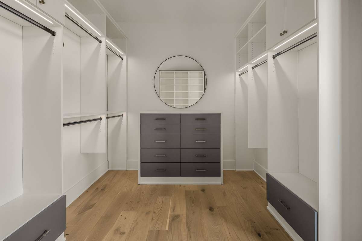 An additional primary closet with distinct his and hers spaces, creating a tailored and highly functional dressing experience.