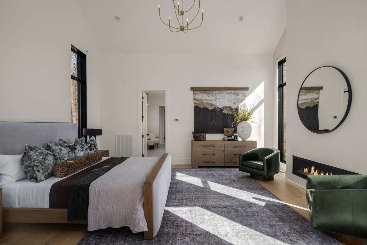 Primary suite offering a serene retreat with abundant natural light, a gas fireplace, and generous proportions designed for comfort and relaxation.