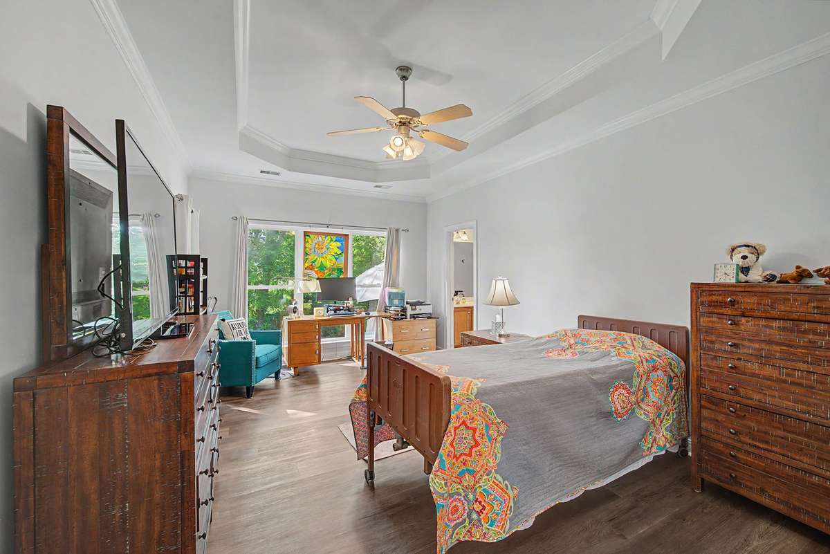 The large primary suite overlooks the lush backyard.