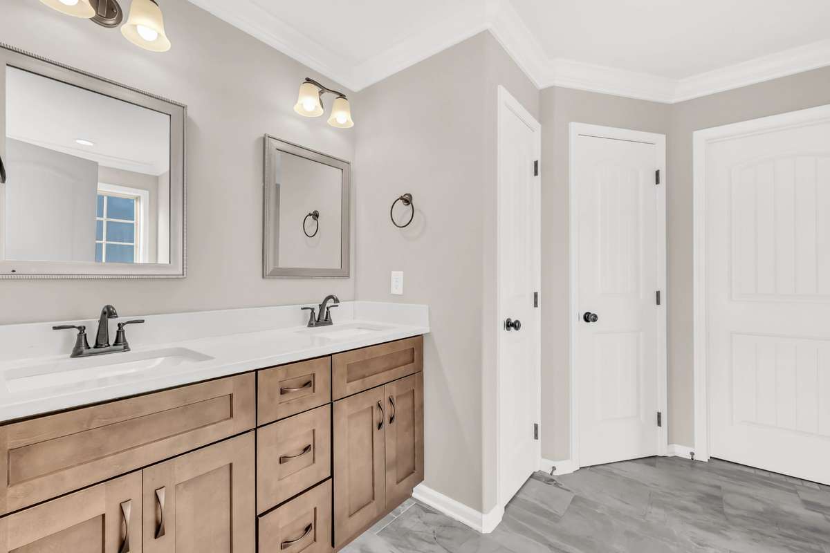 Primary Bathroom features a Large Tile Shower, Double Vanity & a Toilet Closet!