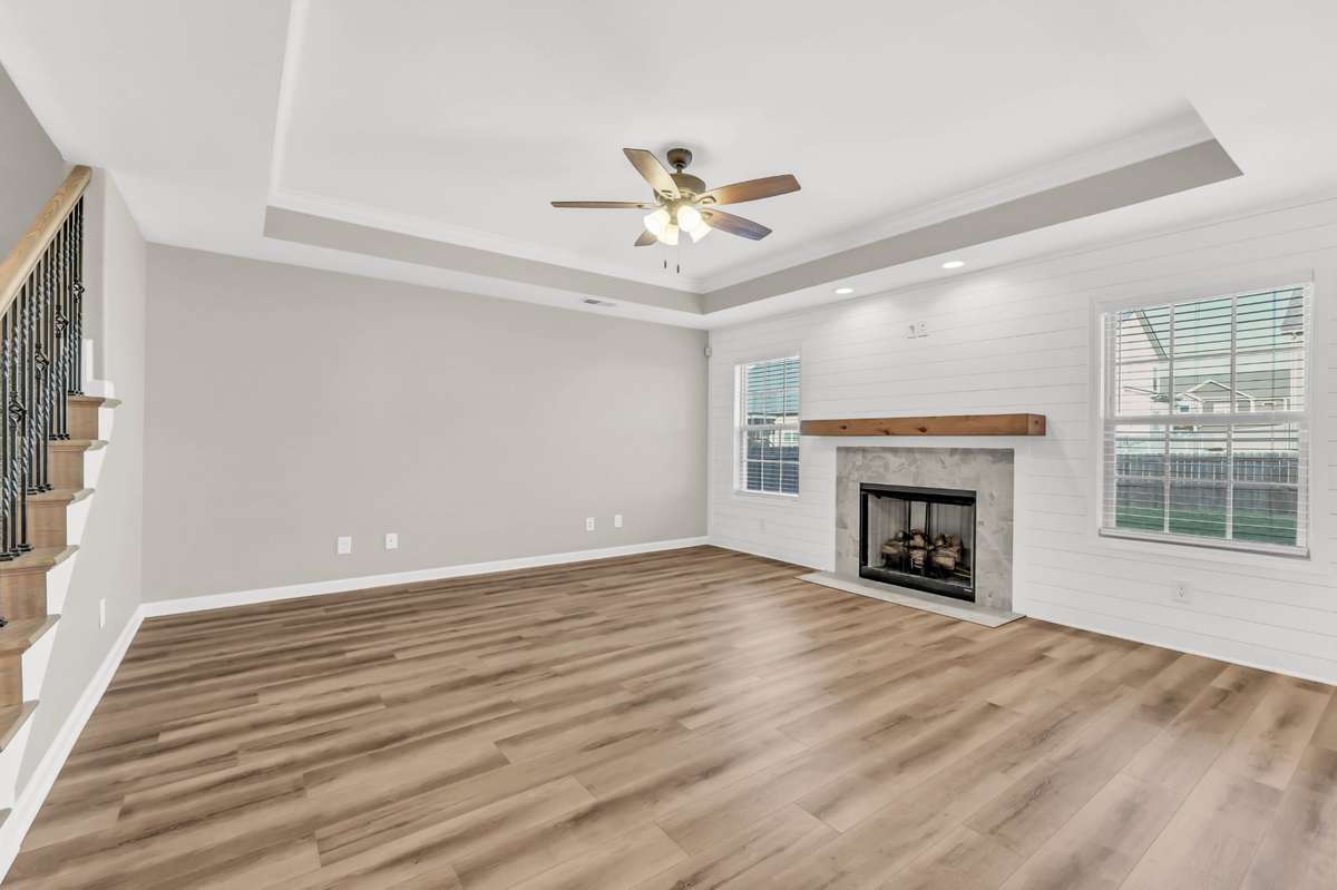 Living Room Features a Natural Gas Fireplace, Tray Ceiling & New LVP Flooring!