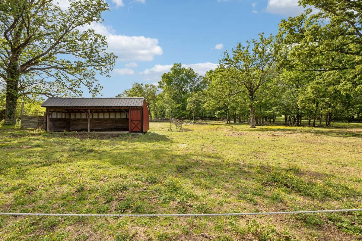 Barn with a riding rink behind